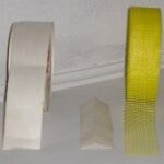 Rolls of paper and self-adhesive fiberglass drywall tape.