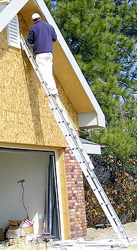 Craig Crowder using an extension ladder.