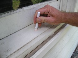 Testing a window sill for lead paint using a LeadCheck test kit.