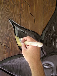 Applying Wood Varnish to the carved areas.