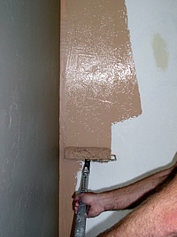 Painting walls with a roller.