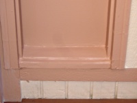 Rotted front door sidelight sill patched and painted.